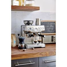 an espresso machine sitting on top of a wooden counter