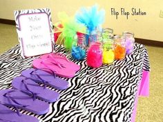 a table topped with flip flops and other items on top of a zebra print cloth