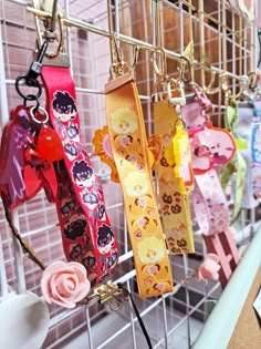 several different colored dog collars hanging on a rack