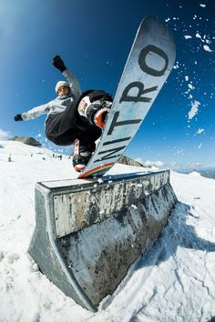 a man riding a snowboard down the side of a ramp