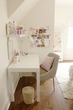 a white desk and chair in a small room