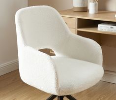 a white chair sitting on top of a hard wood floor next to a wooden desk