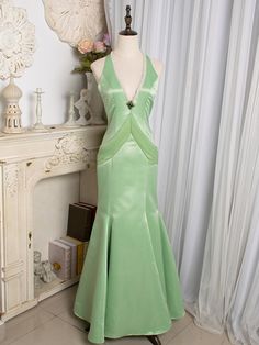 tep into a world of timeless elegance with our Light Green Cutout Back V-neck Vintage Mermaid Skirt Gown. This enchanting gown features a soft, light green hue that exudes a fresh and delicate charm. The V-neckline accentuates your décolletage, adding a touch of sophistication to the overall look. ​The gown boasts a mermaid silhouette, hugging your curves and flaring out gracefully at the hem, creating a stunning, vintage-inspired shape. The cutout back design adds a modern twist, ensuring you m Elegant V-neck Pageant Dress, Elegant Floor-length Pageant Gown, Fitted V-neck Mermaid Dress With Sweep Train, Fitted Green Evening Dress For Pageant, Elegant V-neck Gown For Pageants, Embellished V-neck Mermaid Wedding Dress, Elegant Sweep Train Dress For Pageants, Elegant Dresses With Sweep Train For Pageant, Elegant Sweep Train Dress For Pageant