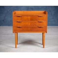 a wooden dresser with three drawers on one side and an open drawer on the other