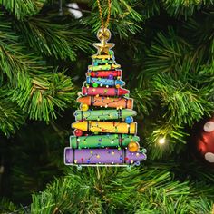 a colorful christmas tree ornament hanging from a christmas tree