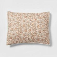 an orange and white pillow on a white background