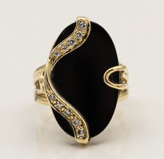 "\"Oval Onyx Splendor 14K Gold Estate Ring with 10 Diamonds\" Description: Presenting the \"Oval Onyx Splendor 14K Gold Estate Ring,\" a one-of-a-kind masterpiece that combines the timeless beauty of onyx with the brilliance of diamonds. This custom-made ring is a true testament to elegance and individuality. Key Features: 1. Stunning Onyx Centerpiece: At the heart of this exquisite ring lies a captivating oval onyx gemstone, exuding an aura of mystique and sophistication. Its deep, lustrous bla Exquisite Oval Jewelry For Evening, Fine Jewelry Oval Evening Jewelry, Exquisite Oval Rings For Evening, Oval Jewelry With Polished Finish For Evening, Oval Yellow Gold Rings For Evening, Gold Oval Cabochon Ring With Diamond Accents, Gold Rings With Diamond Accents And Oval Cabochon, Elegant Oval Rings With Stone Setting, Oval Rings With Polished Finish For Evening