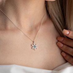 This unique snowflake necklace with birthstones is the perfect way to show your loved ones how much you care. The snowflake is a symbol of winter beauty and uniqueness, just like the person you are giving it to. The birthstone adds a personal touch, making the necklace even more special. The necklace is made of high-quality sterling silver and features a delicate snowflake pendant with a sparkling birthstone of your choice.  This necklace is perfect for any occasion, whether it's a birthday, ann White Snowflake Jewelry For Anniversary, Snowflake Necklace For Christmas Anniversary, Christmas Gift Cubic Zirconia Necklace, Christmas Snowflake Necklace For Anniversary, Cubic Zirconia Necklace For Christmas, Snowflake Cubic Zirconia Jewelry For Anniversary, Cubic Zirconia Snowflake Jewelry For Anniversary, Anniversary Snowflake Cubic Zirconia Jewelry, White Cubic Zirconia Snowflake Necklace