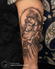 a woman's arm with a tattoo on it and an image of the hindu god