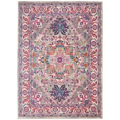 a pink and blue rug with an ornate design on the center, surrounded by multicolored flowers