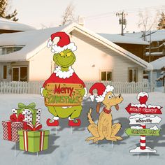 the grinch is standing in front of christmas yard signs and gift boxes with presents on them