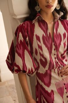 De Castro showcases a seamless and unique blend of traditional Indian craftsmanship, contemporary design, and the founder’s Colombian heritage. Every piece is handmade by artisans, using time-honored techniques and the finest cotton and silk fibers, resulting in exceptional quality, sustainability, and style. Crafted in sumptuous, handwoven silk ikat, the Burgundy Jodhpur Dress is cut with a fitted body, and boasts a collared neckline as well as delightful, ballon sleeves. Product Details 100% s Ikat Outfits Style, Collar Dress Design, Unique Ethnic Wear Indian, Turkish Fashion Traditional, Ikat Dress Designs, Silk Dresses Indian, Business Dress Outfits, Indian Dress Designs, Unique Indian Outfits