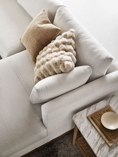 a white couch with two pillows on it