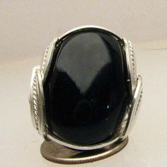 "Handmade Sterling Silver Wire Wrap Black Onyx Ring Sizing and shipping is ALWAYS FREE with a 14 day \"No Questions Asked\" return policy. Gemstone sizes available: XS (16x12mm 5/8x1/2 inch) S (18x13mm 3/4x1/2 inch 10+ct) M (25x18mm 1x3/4 inch 20+ct) L (30x22mm 11/8 x7/8 inch 25+ct) *In the notes section of your order, please specify ring size and gemstone size (XS-S-M-L).* This ring is made with real gems. I made it myself, so if you see a setting you like and want a different gem in it, I can Black Oval Cabochon Jewelry, Oval Black Cabochon Jewelry, Handmade Oval Onyx Rings, Vintage Black Oval Cabochon Ring, Oval Onyx Cabochon Ring, Oval Cabochon Onyx Ring, Oval Onyx Ring With Cabochon, Sterling Silver Wire Wrap, Family Jewellery