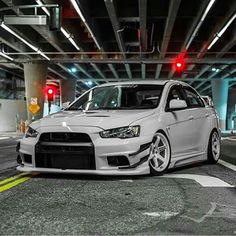 a white car parked in an underground parking garage