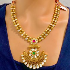 Engraved and detailed Finest Quality Kundan Gold Plated semi-precious emerald and ruby necklace set. This is a stylish set in a golden tone. This set will work well with a traditionally formal and a western formal. Eye-catching and unique jewelry that will set you apart. Gift this piece to a loved one, and see their face light up with joy. Best for gifting or for personal use, wear it to any occasion and become the spotlight. Traditional Gold Plated Necklaces With Jewels, Gold Chandbali Bridal Necklace Jeweled, Gold Chandbali Bridal Necklace With Jeweled Details, Gold Chandbali-shaped Jeweled Bridal Necklace, Gold Emerald Necklace With Intricate Design For Celebration, Gold Jeweled Bridal Necklace In Temple Jewelry Style, Gold Emerald Necklace With Intricate Design For Festive Occasions, Traditional Gold Emerald Gemstone Necklace, Festive Gold Emerald Necklace With Intricate Design