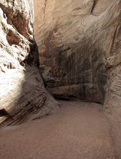 a narrow slot in the side of a mountain with rocks and dirt on both sides