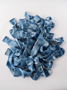 a pile of blue fabric sitting on top of a white table