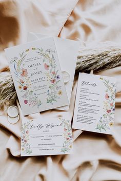 the wedding stationery is laid out on the bed