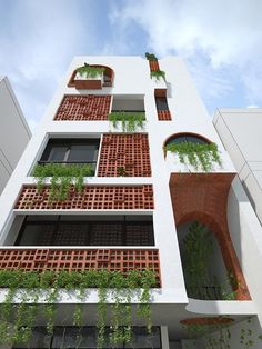 an apartment building with plants growing on the balconies and brickwork around it