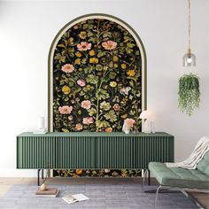 a living room with a green cabinet and floral wallpaper