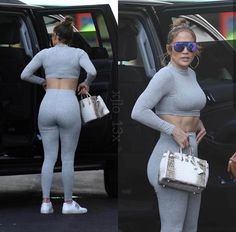 a woman in grey sports bra top and leggings holding a purse while standing next to a car