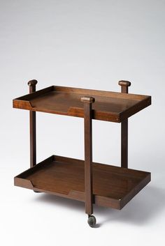 a wooden table with two shelves on each side