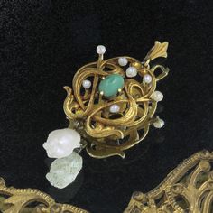 "For your consideration is an antique 14k yellow gold Art Nouveau pendant. This piece features an oval cabochon green turquoise and is accented by seven lustrous seed pearls along the non-symmetrical ends and is finished at the bottom with a large baroque seed pearl which is cream in color. It is engraved \"Emma\" and \"1908\" on the reverse. Item details: Metal - 14k gold Pendant Size - 40x20mm Weight - 3.7 grams Main Gemstone - Turquoise Shape - Cabochon Measurement - 7x5mm Color & Clarity - B Heirloom Green Oval Cabochon Jewelry, Heirloom Green Cabochon Jewelry, Victorian Gold Emerald Jewelry, Elegant Bronze Cabochon Jewelry, Oval Green Brooch Jewelry, Formal Gold Chrysoprase Jewelry, Yellow Gold Chrysoprase Jewelry With Cabochon, Green Jewelry With Intricate Design For Collectors, Art Nouveau Oval Gemstone Jewelry