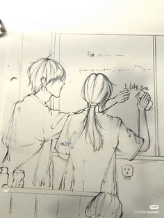 two people standing in front of a drawing