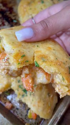 a person holding up a piece of food with shrimp and cheese on it's crust