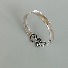 A sterling silver toe ring with hearts. 4mm wide. Weight: o.62 gm This is an open ended toe ring and can be adjusted to fit most feet. These toe rings are made of 925 hypoallergenic sterling silver. Please note this price is for ONE toe ring only. Can be sent in a box. I can include a personal message from you if needed You are welcome to contact me at... bhavnakwintra1956@gmail.com For more beautiful pieces from my shop, please browse 👇 TOE RINGS: https://www.etsy.com/your/shops/TheSilverGame/ Adjustable Sterling Silver Toe Ring With Heart Design, Adjustable Heart Toe Ring For Promise, Adjustable Sterling Silver Heart Toe Ring, Sterling Silver Toe Rings, Silver Toe Rings, Toe Ring, Open Ended, Toe Rings, Ring Sterling Silver