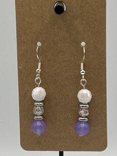 Handmade Earrings - Simplicity Series Each piece is meticulously handcrafted using craft wire, hypoallergenic earring hooks, and premium beads including crystal, glass, wood, ceramic, acrylic, resin, stone, and silicone beads. Care Instructions: Avoid moisture. Remove prior to bathing, showering, swimming, or exercising. Avoid allowing the item to fold when storing.  Shipping Information: Your items will be shipped within 1-2 business days once payment is received. Shipping within the US is via first class mail or you may choose to upgrade to Priority Mail for a small fee. First class shipping is free for orders over $35. Each item is carefully wrapped and packaged for safety during transit. Returns & Exchanges: As this is a wearable item, I do not accept returns or exchanges on this item. Adjustable Purple Earrings With Natural Stones, Handmade Purple Crystal Earrings, Purple Dangle Earrings With Gemstone Beads, Handmade Bohemian Purple Crystal Earrings, Purple Gemstone Bead Dangle Earrings, Evil Eye Earrings, Creating Jewelry, Hypoallergenic Earrings, Silicone Beads