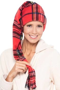 a woman wearing a red and black plaid scarf with a bandanna around her head