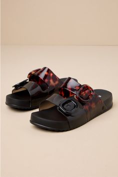 Make your casual days fashionable and extra fun with the Melissa Cozy Black and Clear Tortoise Slide Sandals! A chic combo of black and tortoise print adorns lightweight, slightly clear PVC as it shapes a classic almond-toe bed. Wide vamp straps secure with matching, adjustable buckles, all atop a 0.75"" contoured insole that makes these slide-on sandals perfect for comfortable, everyday wear! Available in whole sizes only. 0. 25" PVC lug sole. Lightly cushioned insole. Rubber sole has nonskid m Chic Black Sandals With Translucent Outsole, Chic Jelly Sandals With Buckle Closure, Black Jelly Sandals With Buckle Closure For Vacation, Black Flat Jelly Sandals With Buckle Closure, Casual Black Slide Jelly Sandals, Casual Black Jelly Slide Sandals, Trendy Black Jelly Sandals For Vacation, Black Adjustable Jelly Sandals, Casual Style, Adjustable Black Jelly Sandals Casual Style