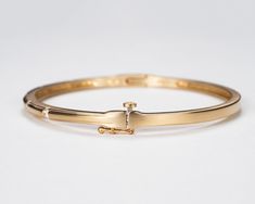 Our beautiful solid gold bezel-set diamond bangle bracelet is a timeless classic that's perfect for your wedding or anniversary, or to add as a family heirloom to your jewelry collection. It features a figure 8 locking hinge for extra security. Made with VS1 diamonds and available in 14k, 18k yellow, rose, white gold and platinum. This bracelet is fully customizable. If you prefer different size dimensions, or moissanites or colored gemstones, please contact us today to get started on a custom o Luxury Anniversary Bangle With Bezel Setting, Yellow Gold Bangle Diamond Bracelet With Bezel Setting, Yellow Gold Diamond Bangle Bracelet With Bezel Setting, Yellow Gold Diamond Bangle With Bezel Setting, Classic Diamond Bangle With Polished Finish, Formal 14k Gold Bangle With Single Cut Diamonds, Classic Yellow Gold Bangle With Brilliant Cut, Formal Yellow Gold Bangle With Bezel Setting, Yellow Gold Bangle With Bezel Setting