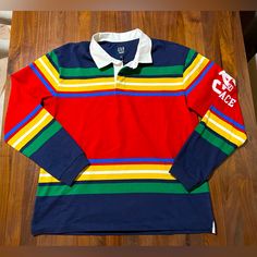 Palace Gap Rugby Shirt Navy Multi Stripe Men’s Size Large Ss24 Logo 90s Retro 100% Authentic Guaranteed. Brand New With Tags. Sold Out / Deadstock. Fast And Free Shipping. Fit & Sizing * Fit: Relaxed. A Straight & Easy Fit. * Style Note: For A More Classic Fit, Go Down One Size. Hits At The Hip. Product Details Karl Watson + Pier 7 = Remember That Ween Tune Soft Cotton Rugby Shirt. Point Collar With Button Placket. Long Sleeves With Banded Cuffs. Gap And Palace Logo At Sleeves. Allover Mixed Str Casual Multicolor Polo Collar Shirt, Multicolor Long Sleeve Cotton Polo Shirt, 90s Colors, Vintage Cap, 90s Retro, Retro Color, Rugby Shirt, Fit Style, Fancy Dresses