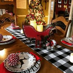 a christmas table setting with red and white plates