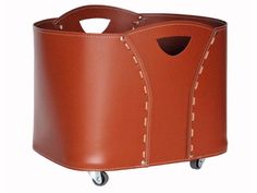 a brown leather storage container on wheels