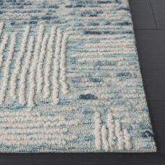 a blue and white rug on the floor