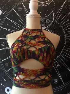 a mannequin wearing a multicolored knitted bralet and matching halter top