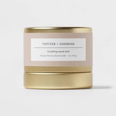 a gold tin with a label on it that says vetiver + oakmoss