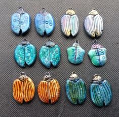 twelve handmade glass pendants in different colors and designs, each with an octopus on the front