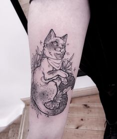 a black and white cat tattoo on the leg