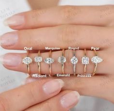 a woman's hand with five different rings and their names on the ring finger