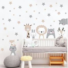 a baby's room with animals and stars on the wall