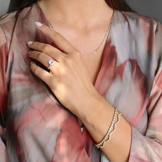 a woman wearing a ring and bracelet