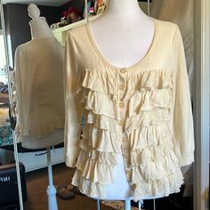 Downeast Sparrow Cream Cardigan With Cute Ruffled Front. Ruffles On Bottom Hem. 3/4 Sleeves With Button Front. Original Tag Price Is $120. Sale Price $44. (A) Cream Button-up Tops For Layering, Spring Blouse With 3/4 Sleeves For Layering, Cream Ruffled Cardigan For Fall, 3/4 Sleeve Cardigan For Spring Day Out, 3/4 Sleeve Cardigan For Fall Day Out, 3/4 Sleeve Cardigan For Day Out In Fall, 3/4 Sleeve Cardigan For Day Out In Spring, Fall 3/4 Sleeve Cardigan For Day Out, Summer Cotton Cardigan With 3/4 Sleeves