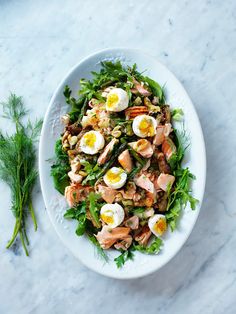 a white plate topped with salad and eggs