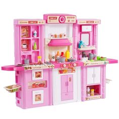 a pink toy kitchen with lots of appliances