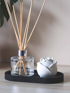 an air freshener and reed diffuser on a table